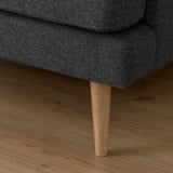 Close-up of a stylish sofa leg, sleek design, high-quality fabric, and sturdy wood for stability.