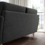 Modern grey GRILLSTORP sofa by window with wooden legs and cushions.