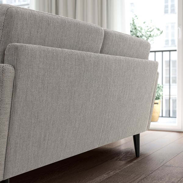 A modern grey GRILLSTORP sofa with sleek design and comfortable cushions. Its a medium-sized sofa, perfectly placed in a well-lit room.