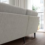 Gray GRILLSTORP sofa on wood floor, near window, medium size.