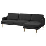 Modern dark grey fabric sectional sofa with wooden legs, sleek design, 4 cushions.