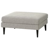 Minimalist GRILLSTORP footstool in light grey fabric with black legs.