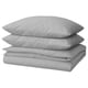 A stack of three light grey, rectangular pillows made from 100% cotton, featuring a simple design.