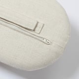 A circular cushion with a beige zipper and quality white fabric, designed for comfort and easy cleaning.