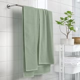 GULVIAL mint towel hangs near plant, showing soft, textured fabric. Size: larger than stack of white towels.