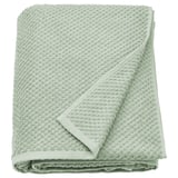 A folded sage green GULVIAL cotton towel, soft and thick, with a textured surface and neat edges.