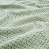 Soft, textured towel with a fluffy appearance, likely made of cotton, featuring a subtle pattern for extra grip.