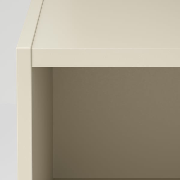 It shows a close-up of a modern white wooden bedside table with a metallic brown surface, highlighting its sleek design and quality materials.