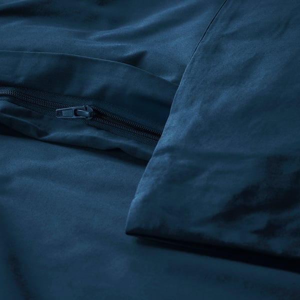 Close-up of dark blue duvet with full-length zipper closure, showcasing its crisp percale weave in a sophisticated, neutral style.