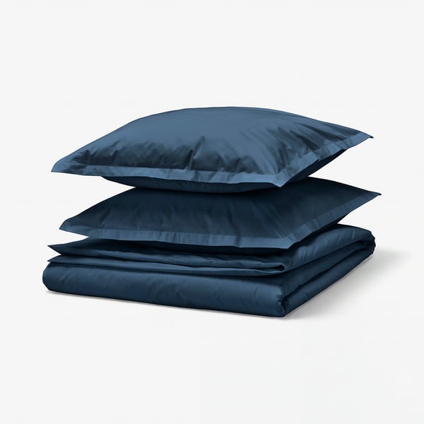 Blue bedding set including duvet and 2 pillowcases made of soft 100% cotton, neatly folded and displayed.