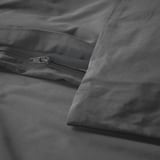 Close-up of a dark grey duvet cover with zipper closure. Crisp, woven cotton fabric.