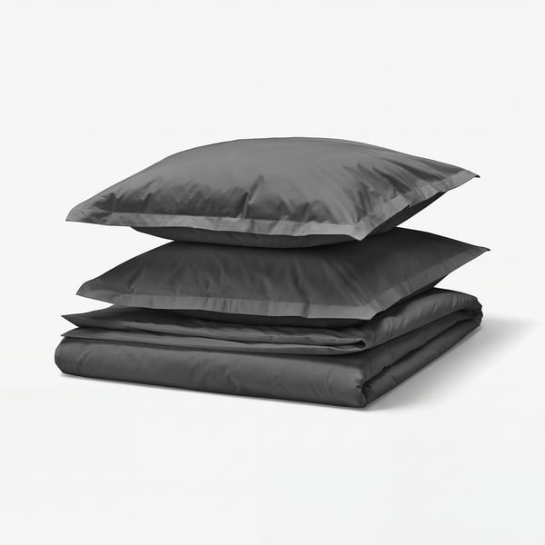 Stacked dark grey bed linens, including a duvet cover and pillowcases, neatly folded.