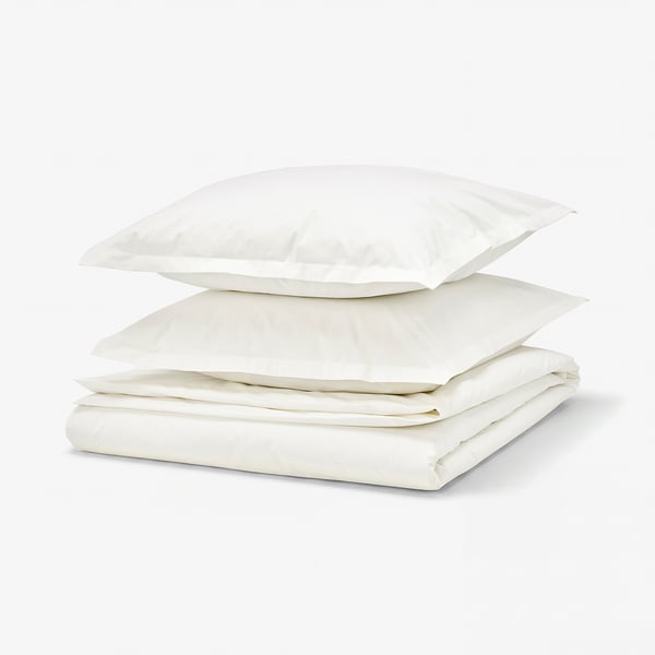 A white HAMPFLOCKEL bedding set made of 100% cotton, featuring a folded duvet cover and two pillowcases with a crisp percale weave and zip closures.