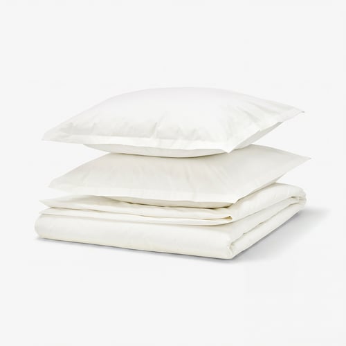 A white HAMPFLOCKEL bedding set made of 100% cotton, featuring a folded duvet cover and two pillowcases with a crisp percale weave and zip closures.