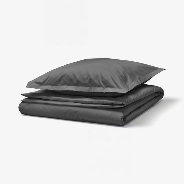 Stacked dark grey bedding: duvet and pillow with zip closures.