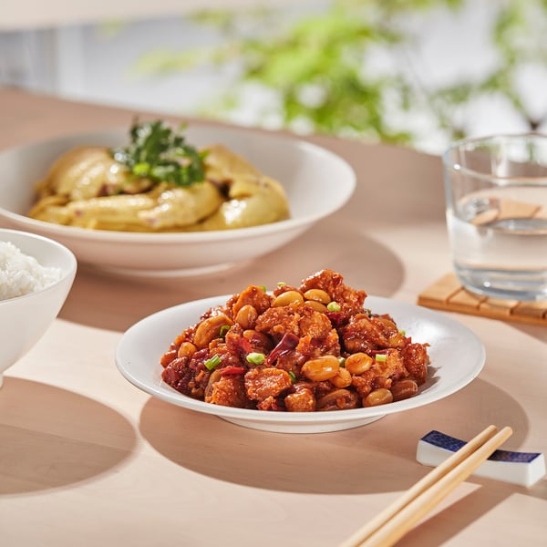 A meal setup with bowls filled with food and chopsticks.