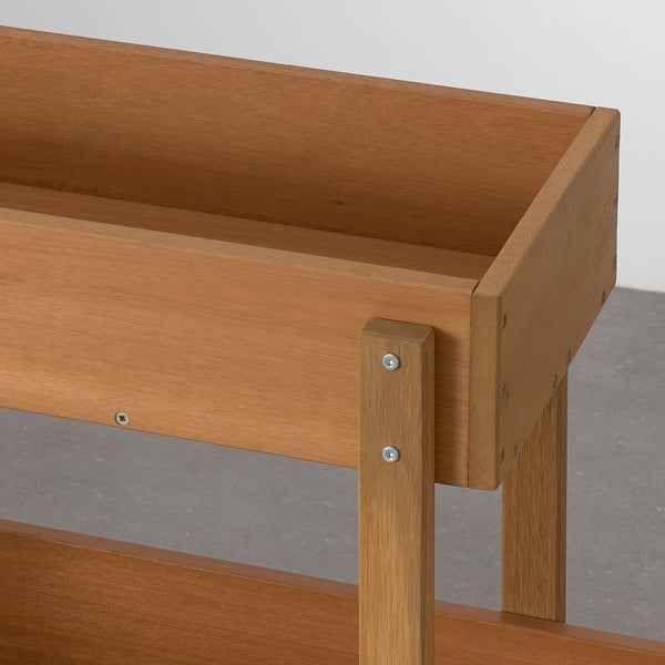 Wooden flower box with sturdy legs and screws, designed for outdoor use.