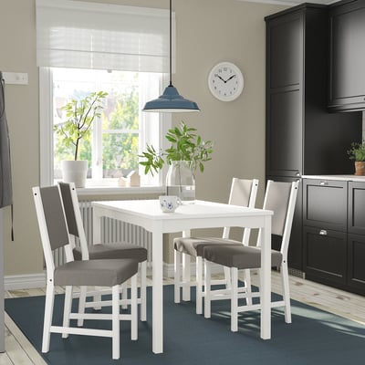 HAUGA dining set with table & 4 grey chairs in kitchen, near window, blue rug, dark cabinets, blue pendant light.