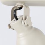 Adjustable ceiling light with soft white finish and black handle.