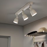 Three adjustable spotlights on a ceiling track, illuminating downward. Part of the HEKTAR series, suitable for directed lighting.