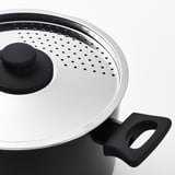 Non-stick cookware, steam holes, black handle, stainless steel lid.