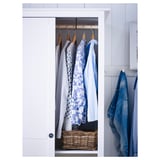 HEMNES white closet with hanging shirts; wooden hangers, wicker basket.