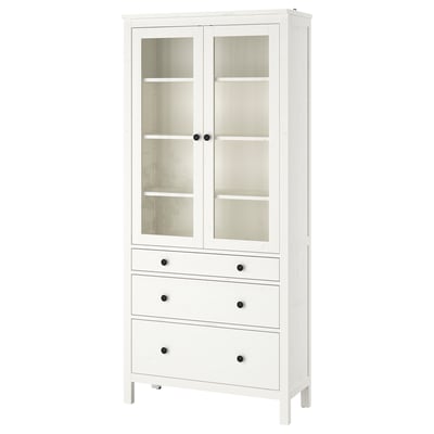 White HEMNES pine wooden display cabinet with glass doors, multiple drawers.
