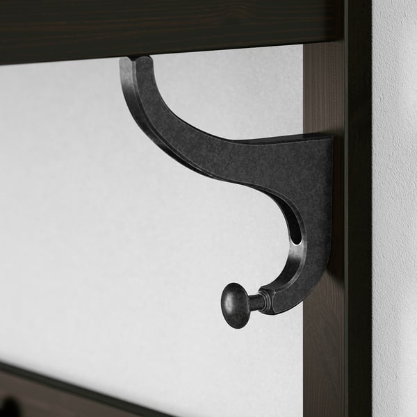 Black metal hook on wooden surface. Sturdy and sleek, part of HEMNES series.