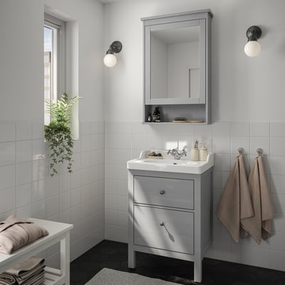 Grey bathroom with HEMNES vanity, mirror, and towel.