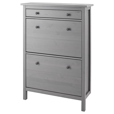 A gray HEMNES shoe cabinet with multiple compartments. It is made of solid pine and has a clean, rectangular design.