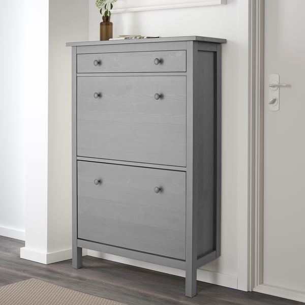 Gray HEMNES shoe cabinet with 6 compartments and 2 drawers. The cabinet stands on legs close to the wall, ideal for saving space.