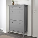 Gray HEMNES shoe cabinet with 6 compartments and 2 drawers. The cabinet stands on legs close to the wall, ideal for saving space.