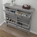 Grey HEMNES shoe cabinet, holds 8 pairs, close to wall.