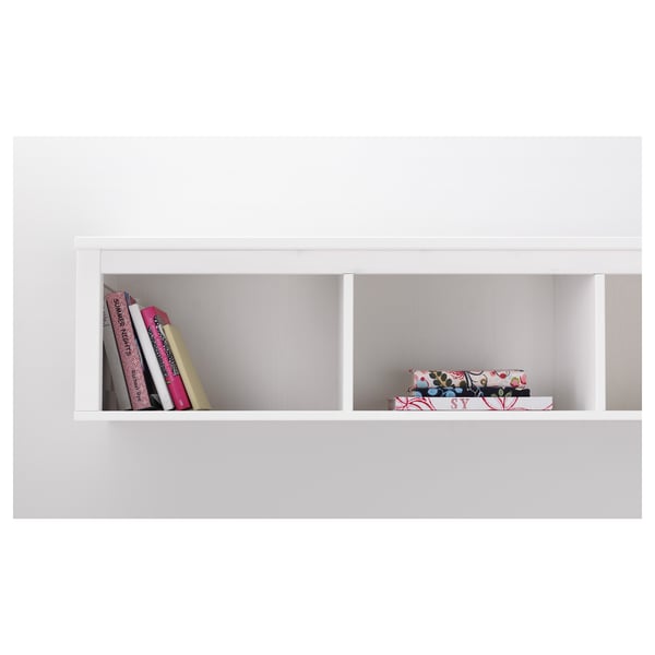 White wall shelf displaying colorful books and decorative boxes. Part of HEMNES series by ikea.