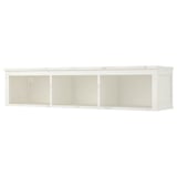 A HEMNES white wall shelf made of solid pine and fiberboard. It has a rectangular, minimalist design with three open compartments.