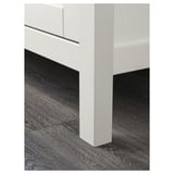 Close-up of modern wardrobe corner, showcasing sleek design and quality wood finish.