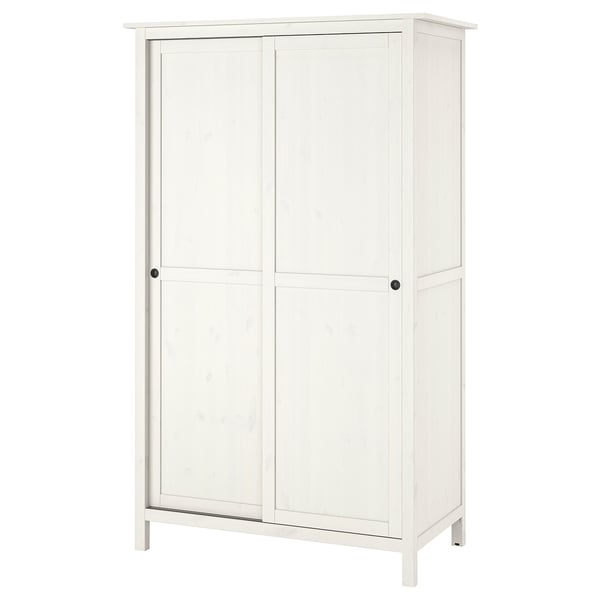A white HEMNES wardrobe with sliding doors, made of solid pine and fibreboard. It a classic design for hanging and folded clothes.