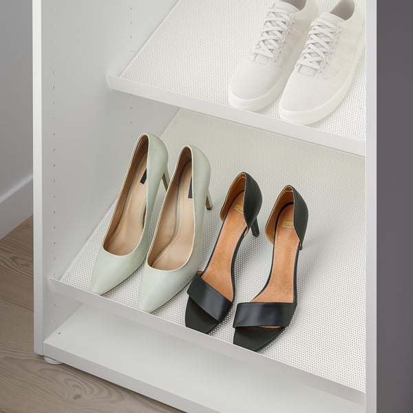 White shoe rack with heels and sneakers