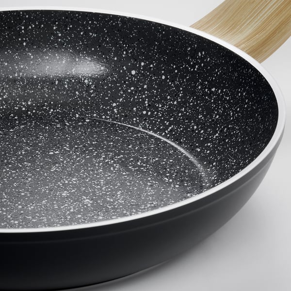 Modern non-stick frying pan with textured black surface and wooden handle.