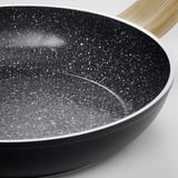 Modern non-stick frying pan with textured black surface and wooden handle.