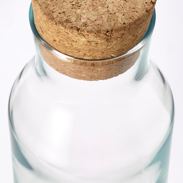Clear glass carafe with cork stopper; simple, durable design.
