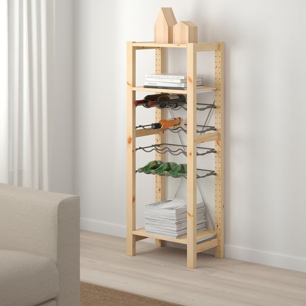 IVAR pine storage unit holds books & wine, taller than couch, minimalist design.