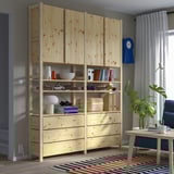 IVAR storage & desk with shelf items, plant, and blue clock.