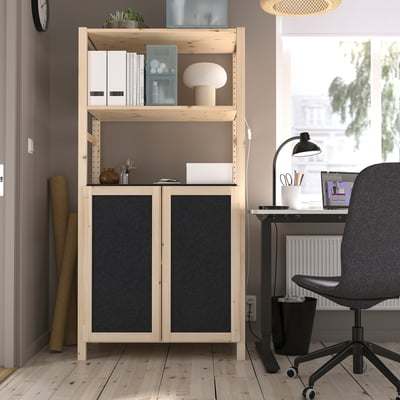 IVAR storage unit in home office with shelves and cabinets.