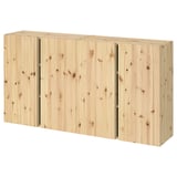 A light-colored wooden IVAR storage unit. Its rectangular, with three sections and adjustable shelves, made of solid pine.