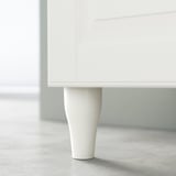 Single white cabinet leg with slight curve; minimalist, modern design.