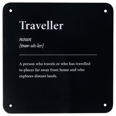 Displays a definition of traveller in white text on a black background. It provides the part of speech, pronunciation, and a brief description.