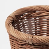 Handwoven rattan basket with intricate, natural design, showcasing high-quality craftsmanship and rustic charm.