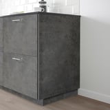 KALHYTTAN cabinet, black, stands tall against white tiled wall, fits in corner, largely unseen items on top.