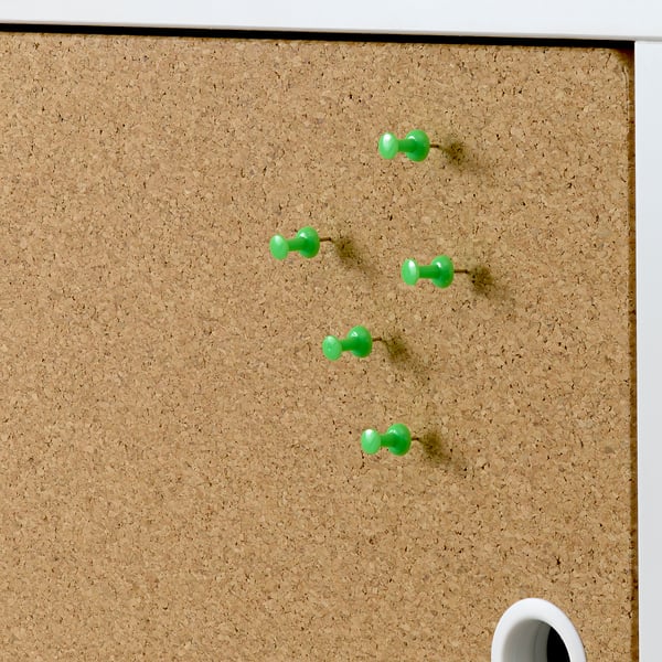 Goal brown cork board with green pushpins, part of KALLAX shelving, ideal for pinning notes or photos.